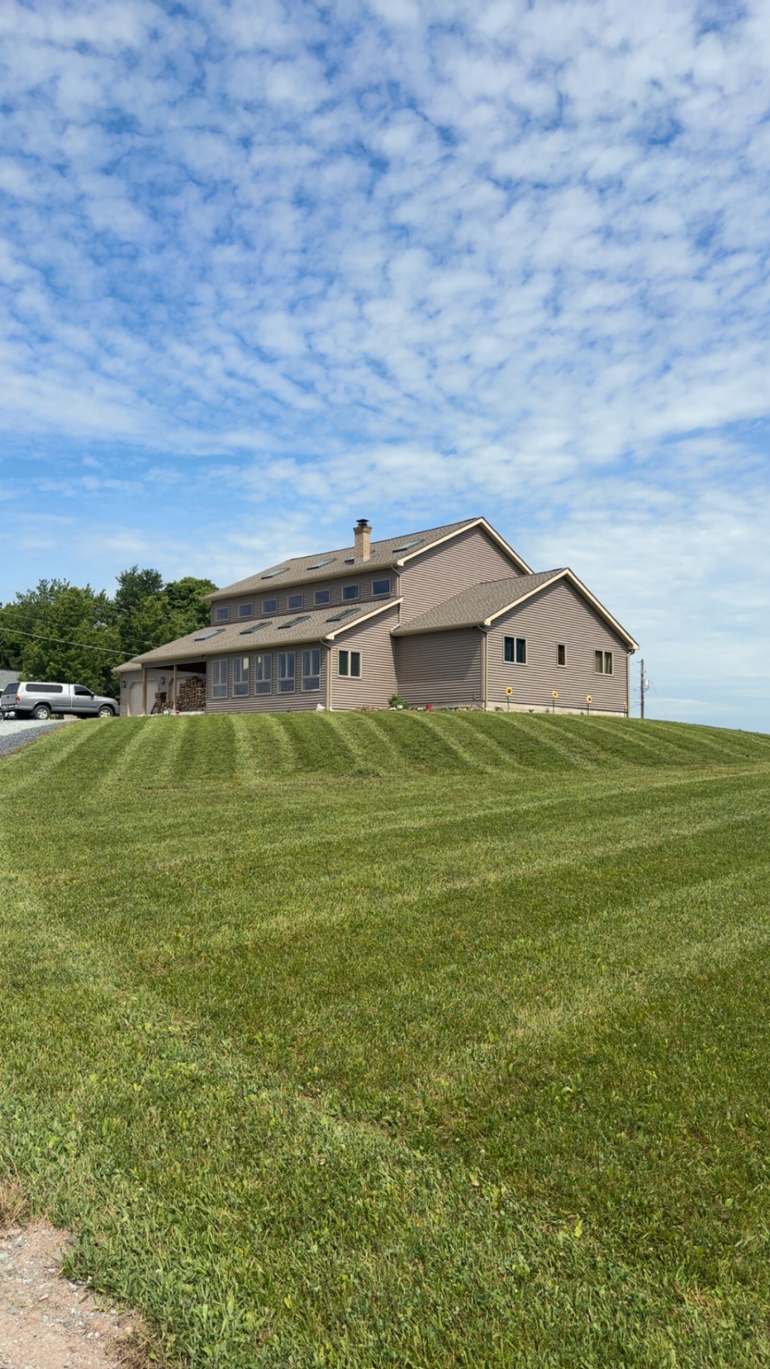 Hillside lawn cut with fresh stripes