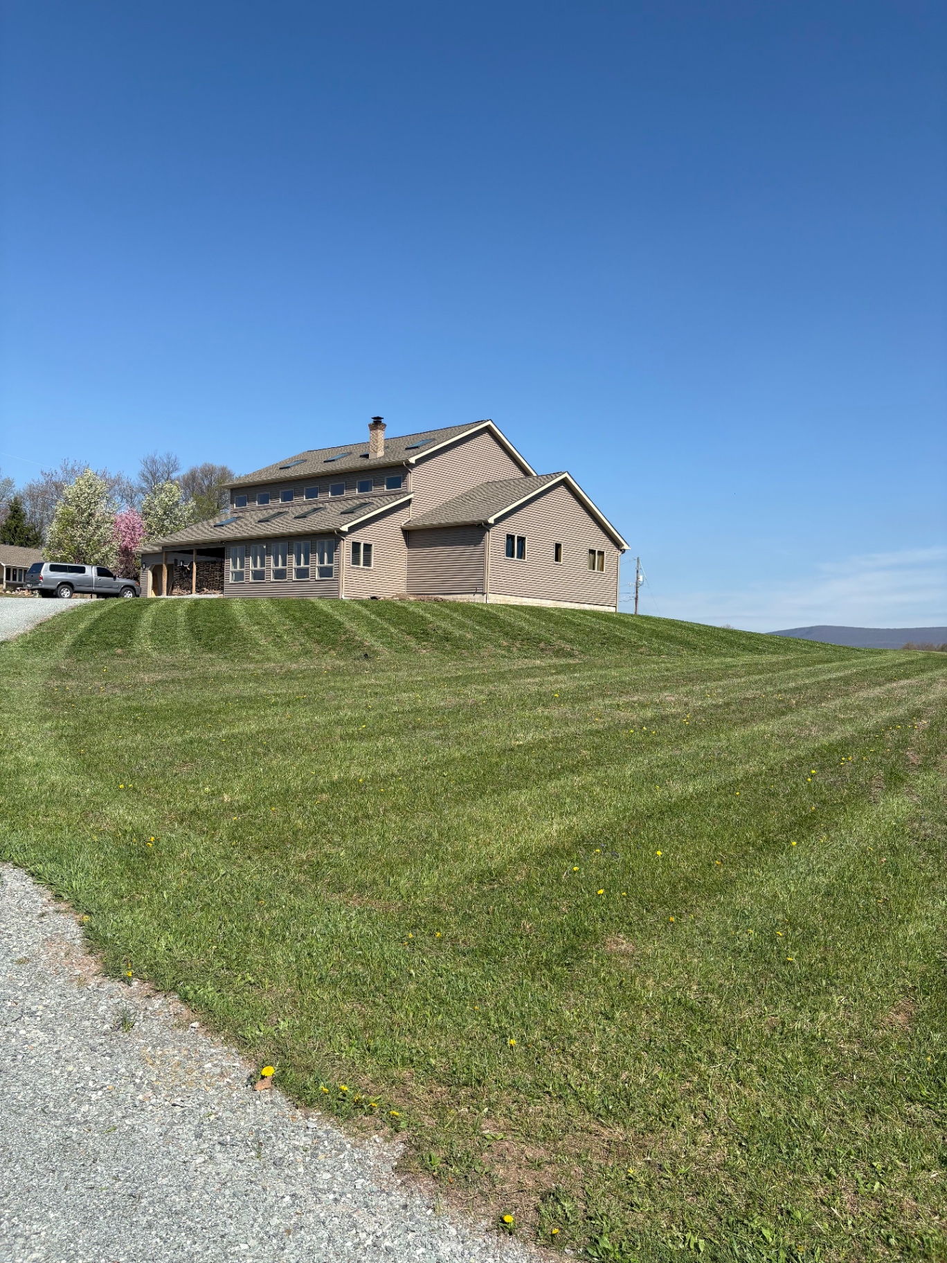 Hilltop lawn cut with crisp stripes